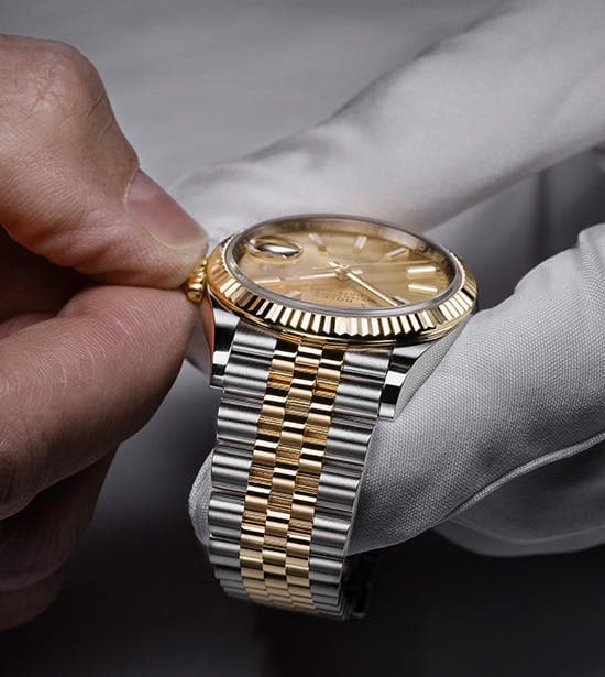 Authorized Rolex expert performing a servicing operation on a Rolex timepiece.