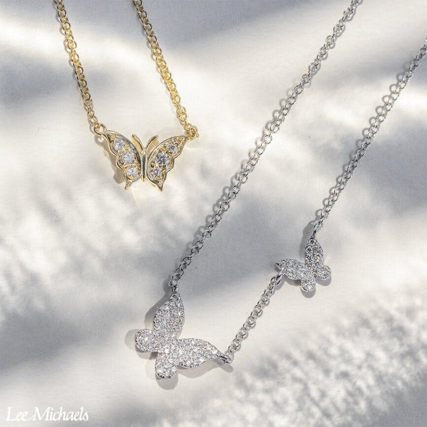 two diamond and gold butterfly necklaces