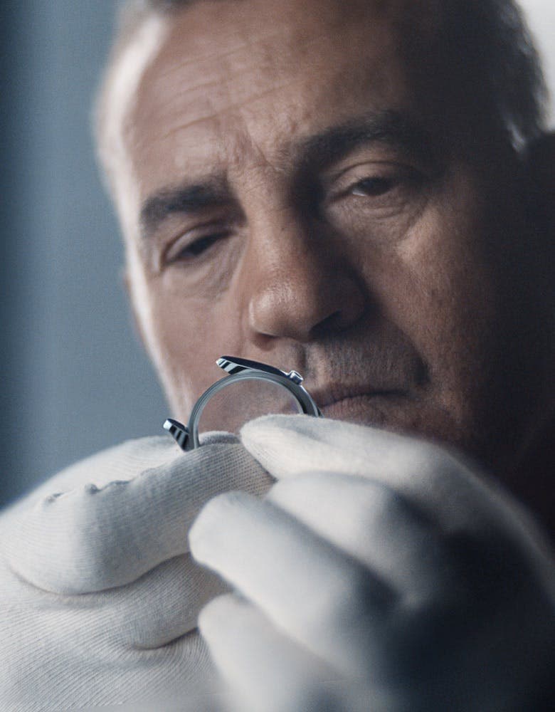 photo of a person inspecting a Rolex watch case