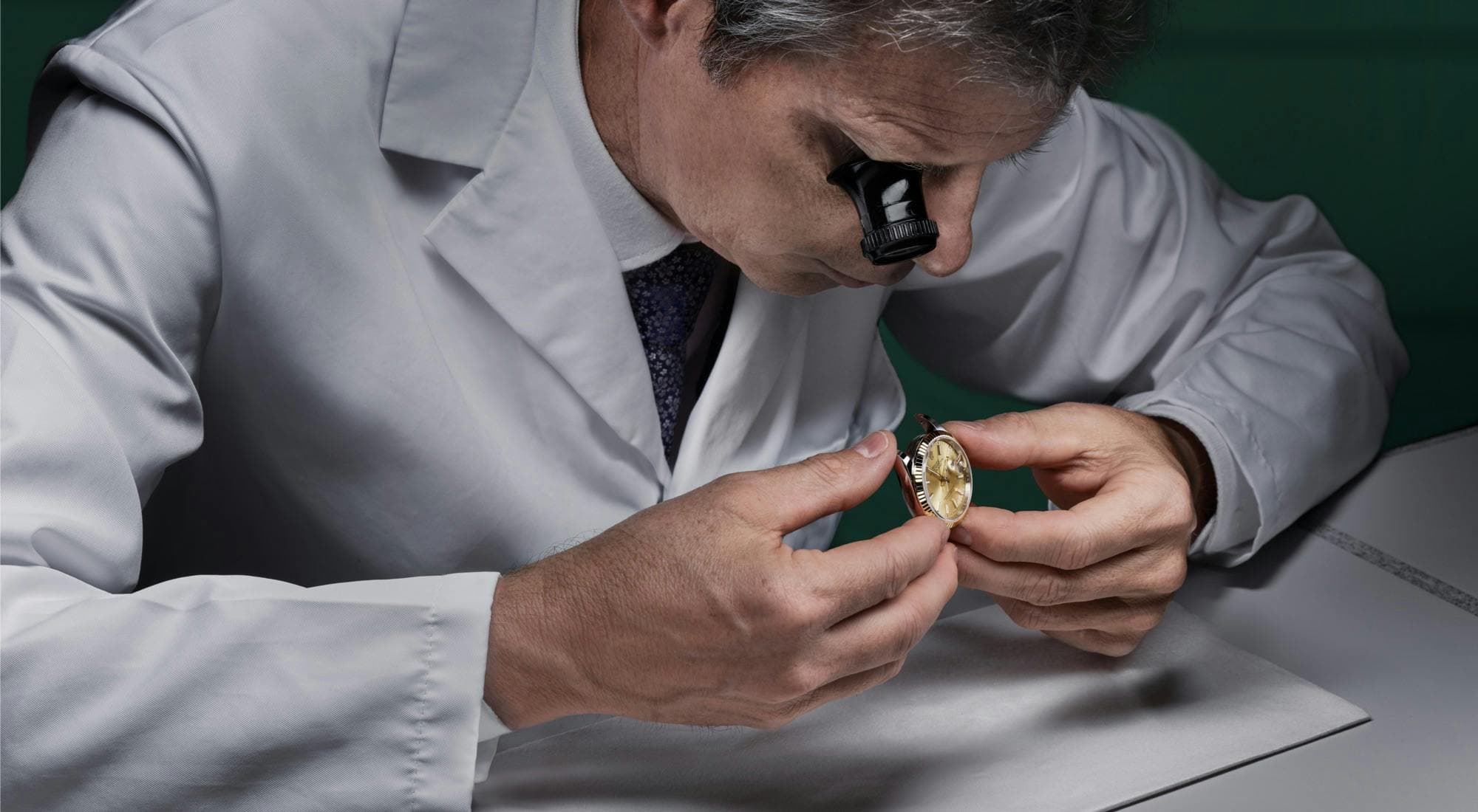 Photo of a Rolex watchmaker inspecting a watch